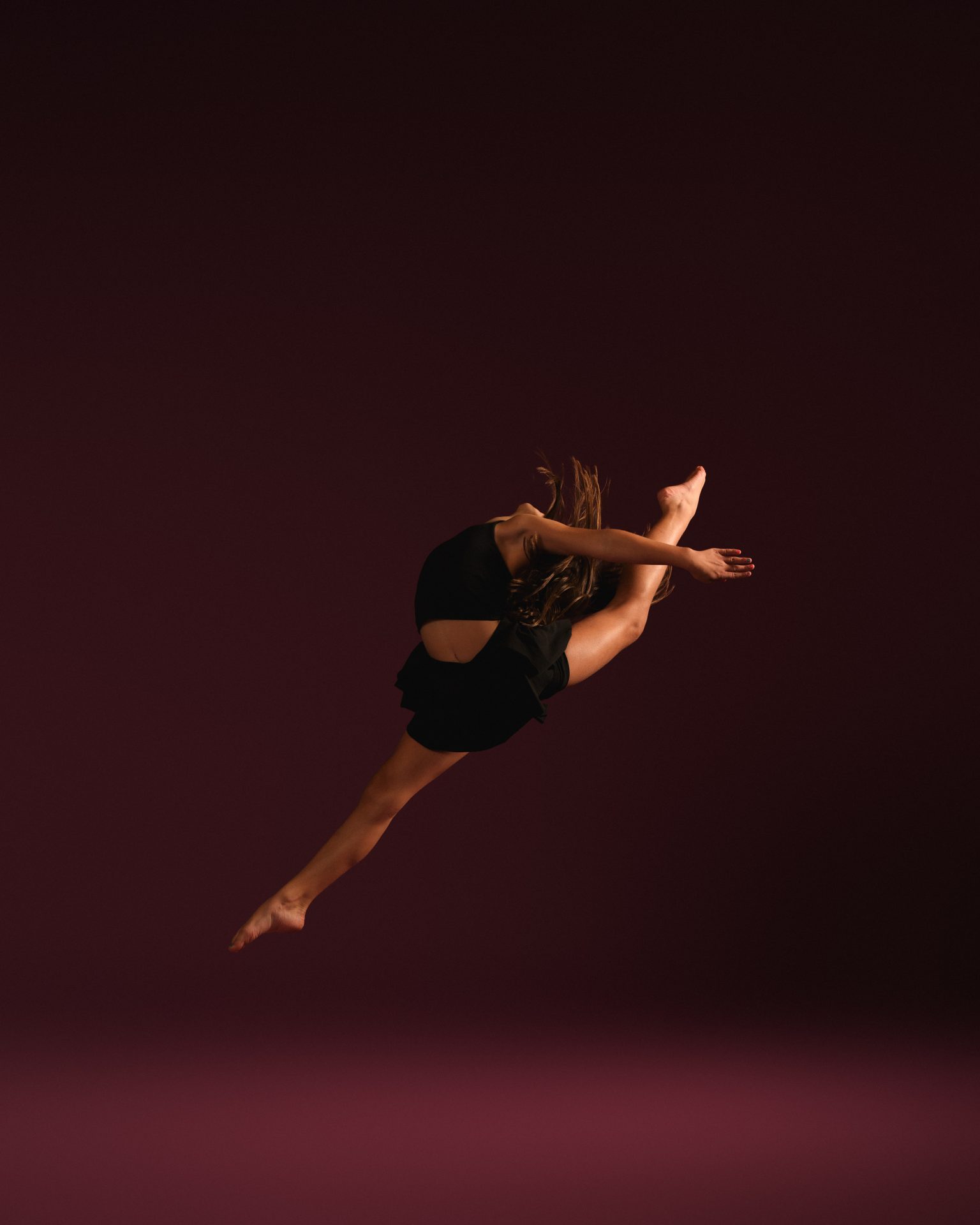Dancer mid-leap in a firebird jump