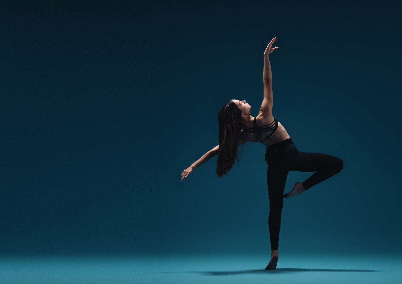 Ambition dancer in a passé balance reaching upward