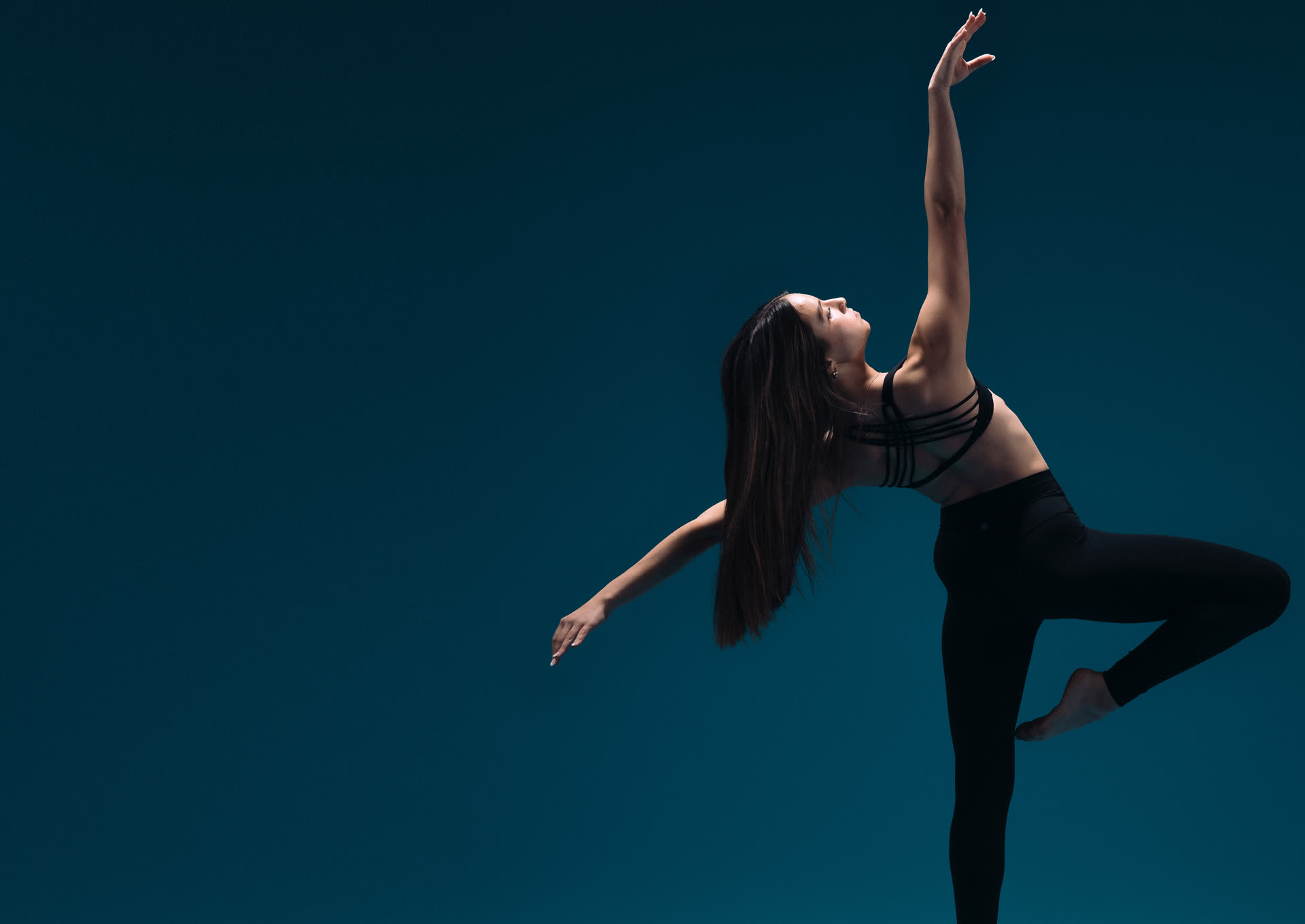 Ambition dancer in a passé balance reaching upward